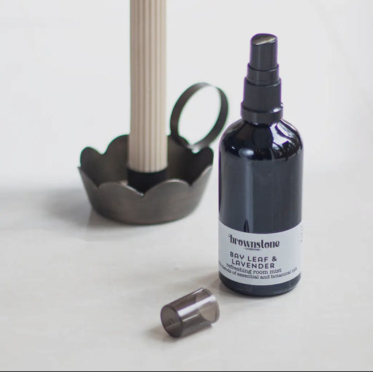 Room mist spray bottle labeled 'Brownstone Bay Leaf & Lavender' on a light background