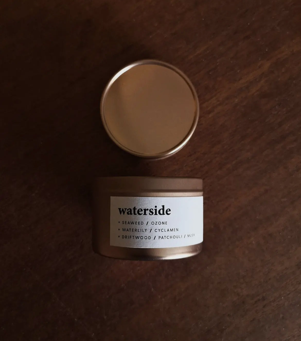 Keynvor Travel Tin Candle labeled 'waterside' on a wooden surface