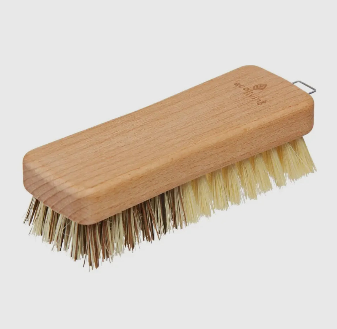 Wooden brush with bristles on a light gray background