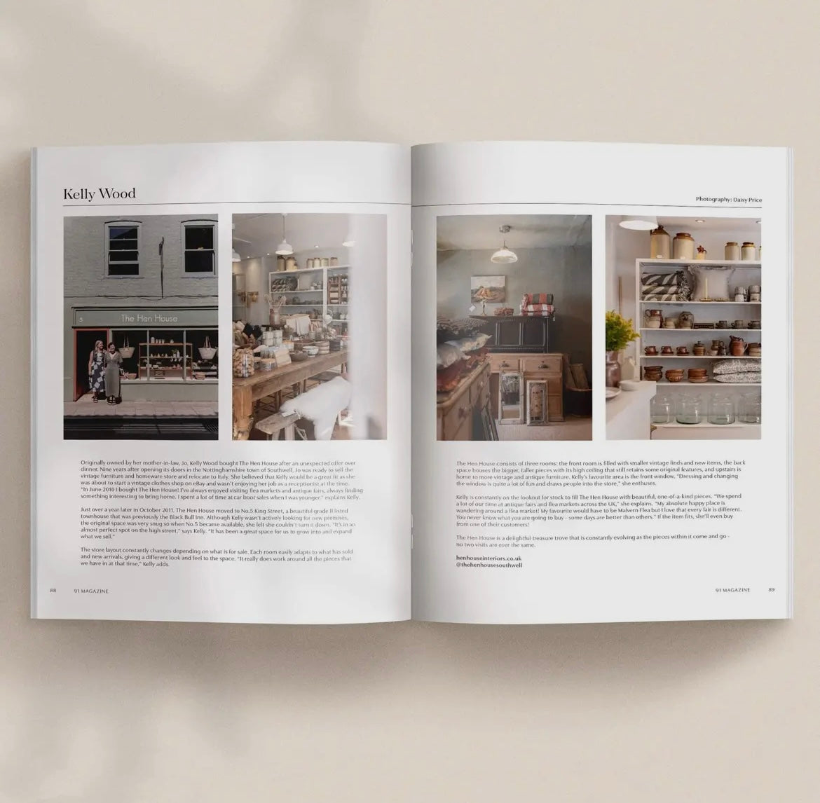 Open book showing interior design images and text on a neutral background