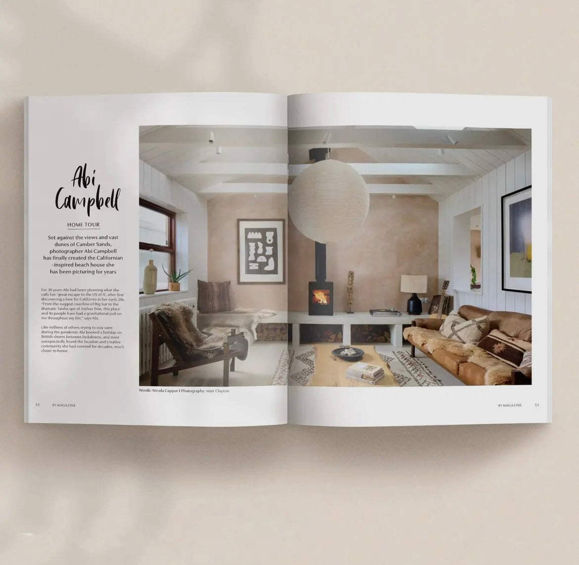 Open magazine showing a living room interior design with Abi Campbell's name.