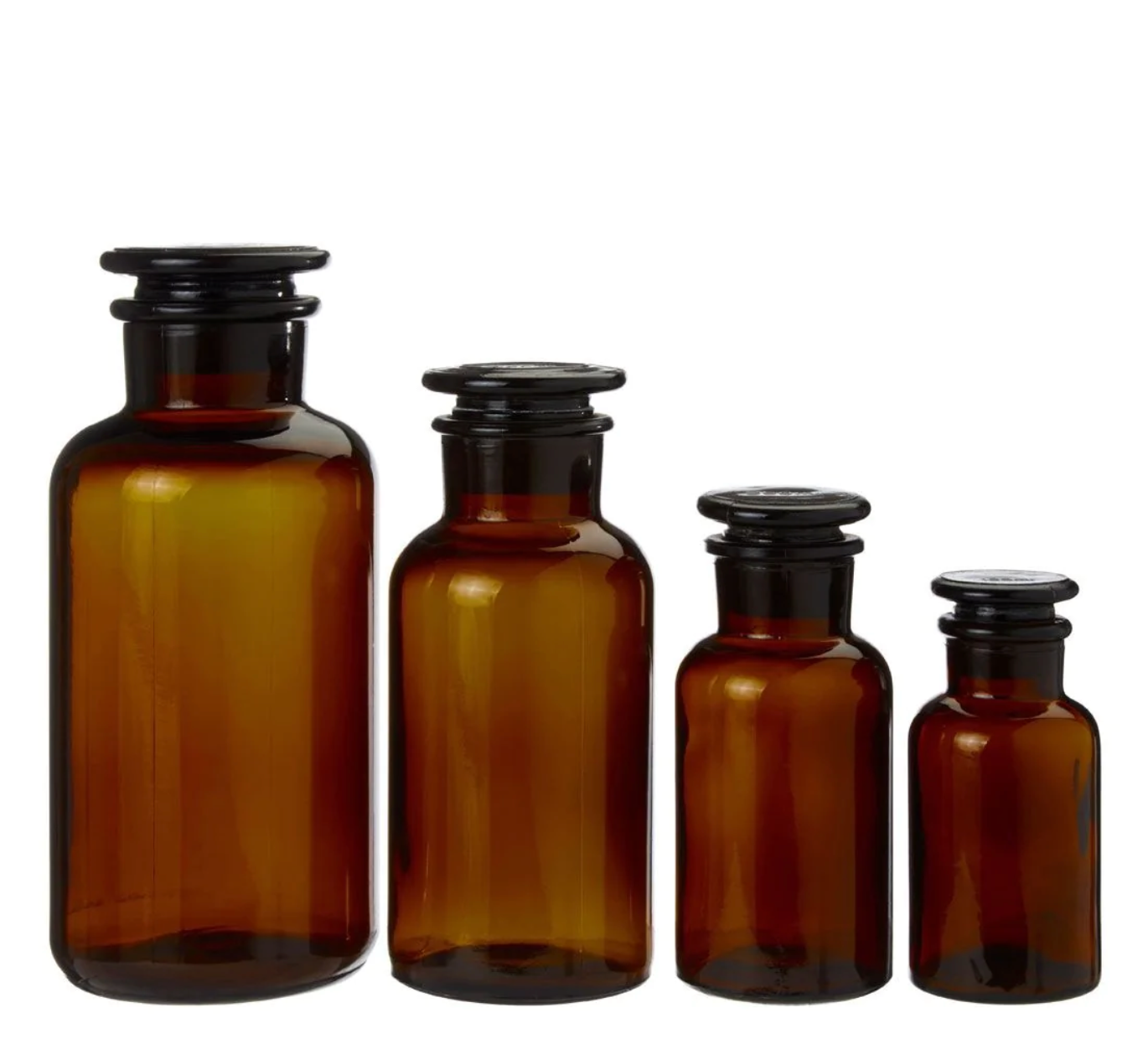 Set of four Apothecary Bottle Storage Jars with black caps on a white background