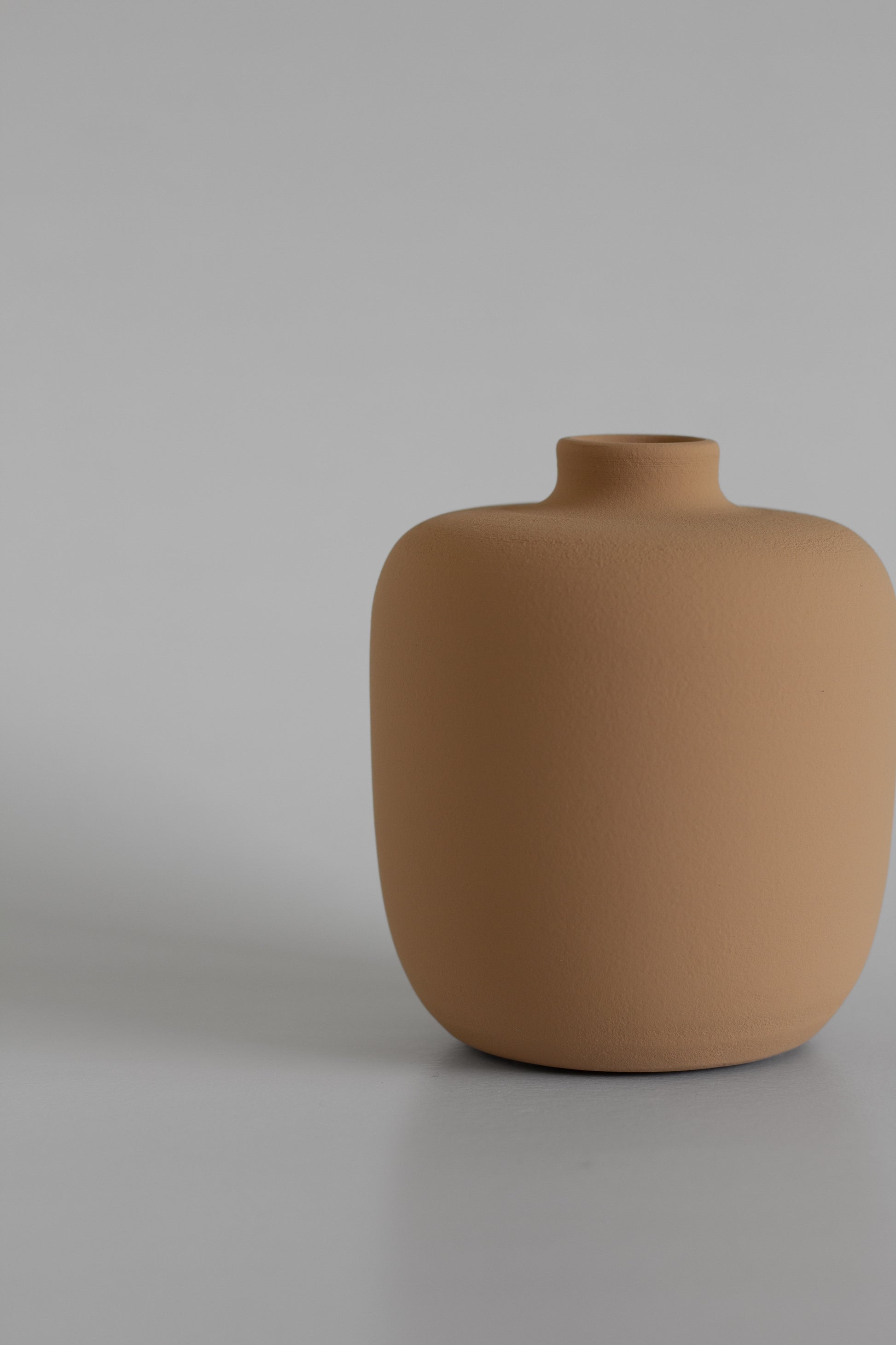 Sand ceramic vase on a grey background