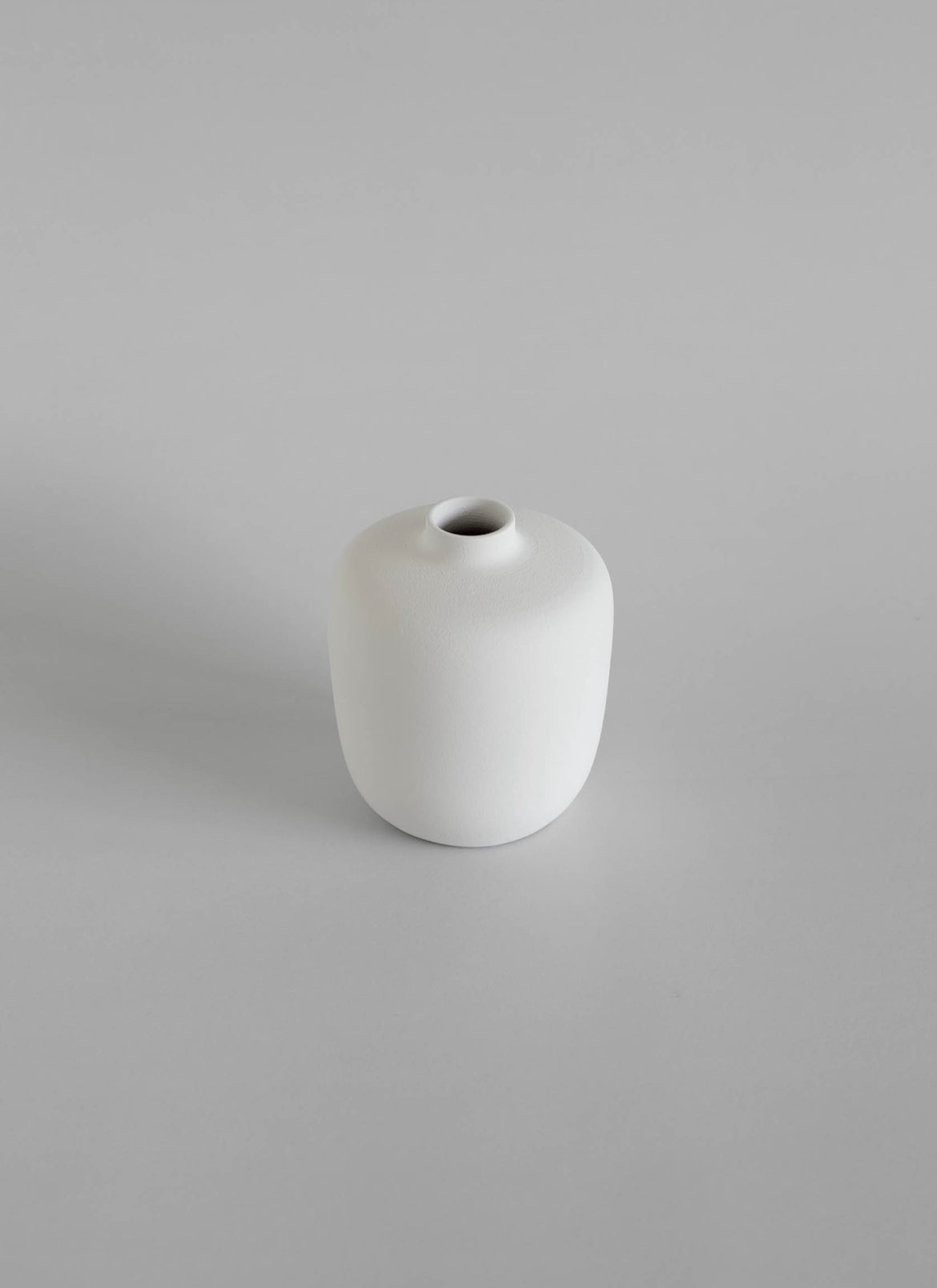 White ceramic vase on a gray background