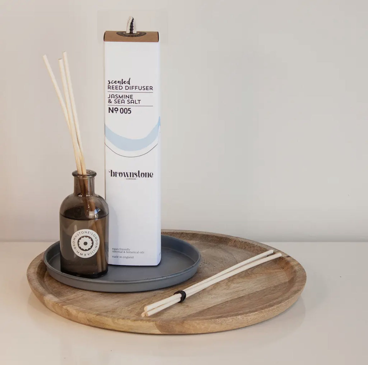 Brownstone London Diffuser with bottle and sticks on a wooden tray