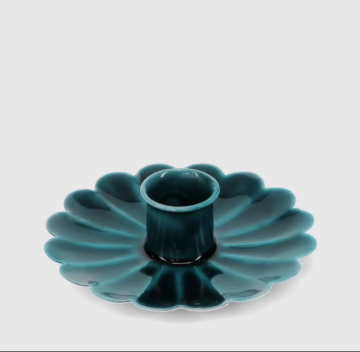 Teal ceramic cake mold on a white background