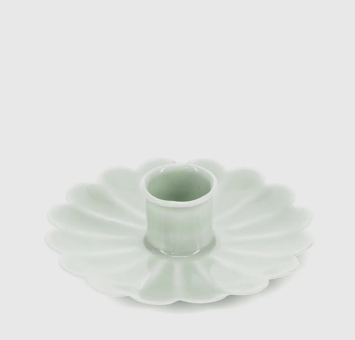 Light green ceramic candle holder on a white background