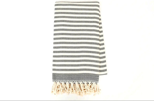 Striped towel with fringes on a white background