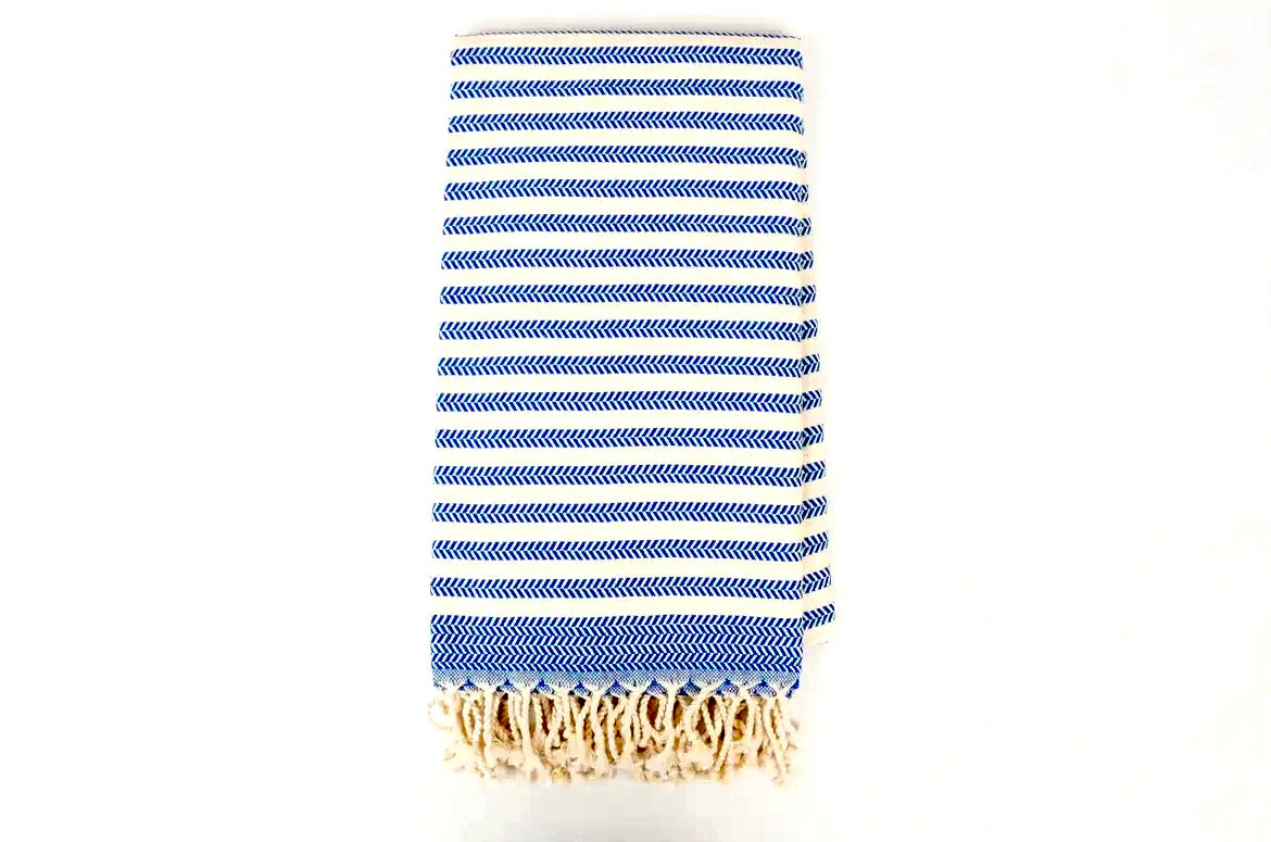 Blue and white striped towel with fringes on a white background