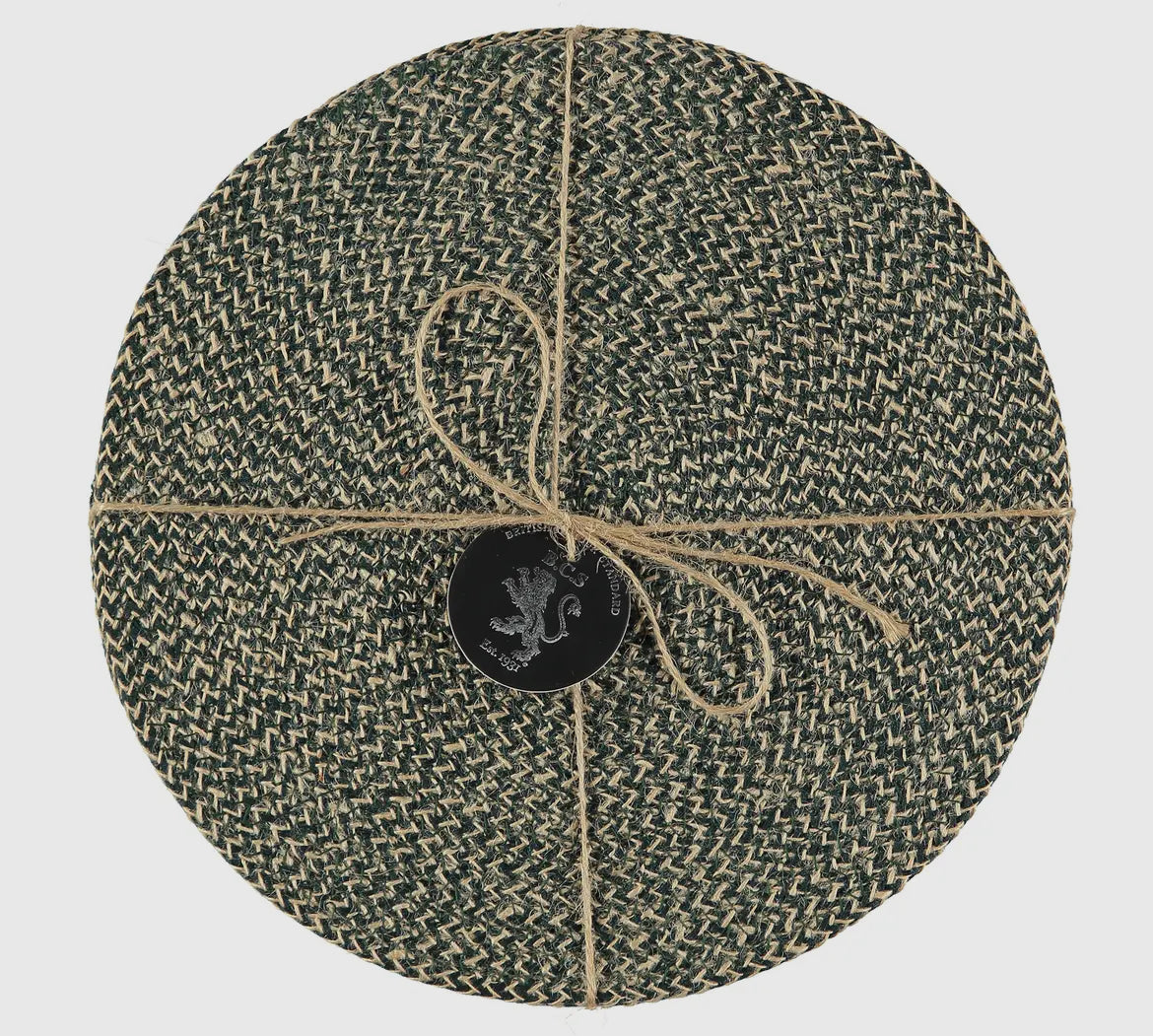 Round woven mat with a central logo on a light gray background