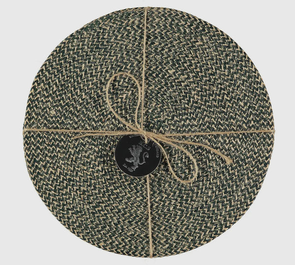 Round woven mat with a central logo on a light gray background