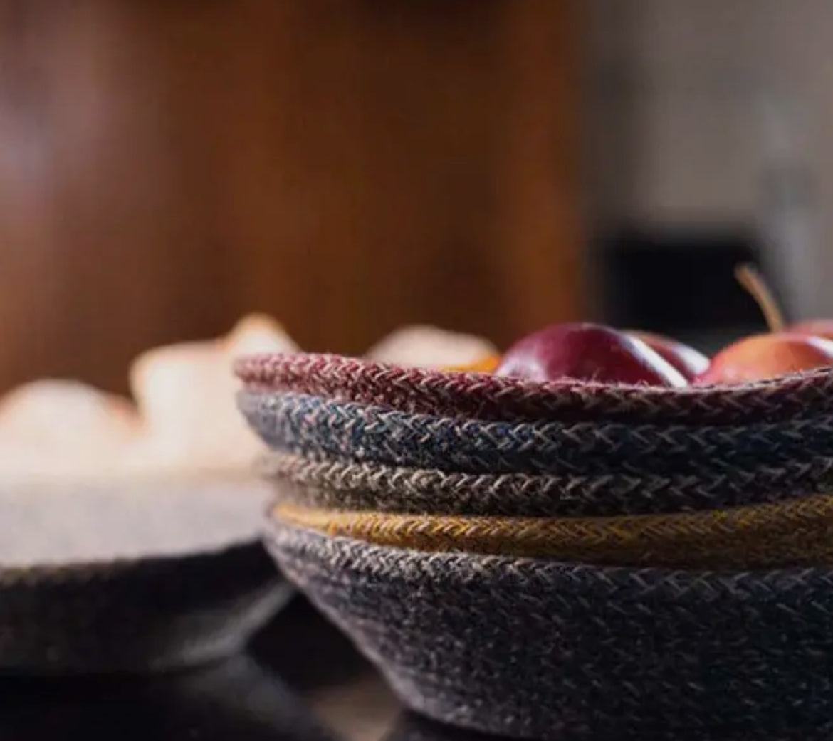 Stack of woven bowls with fruits on a blurred background