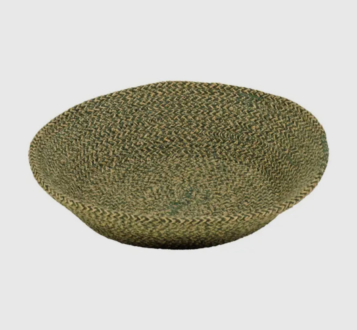 Green woven basket on a light gray background