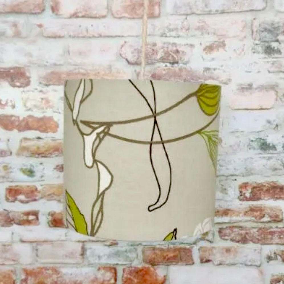 Decorative lampshade with abstract design on a brick wall background