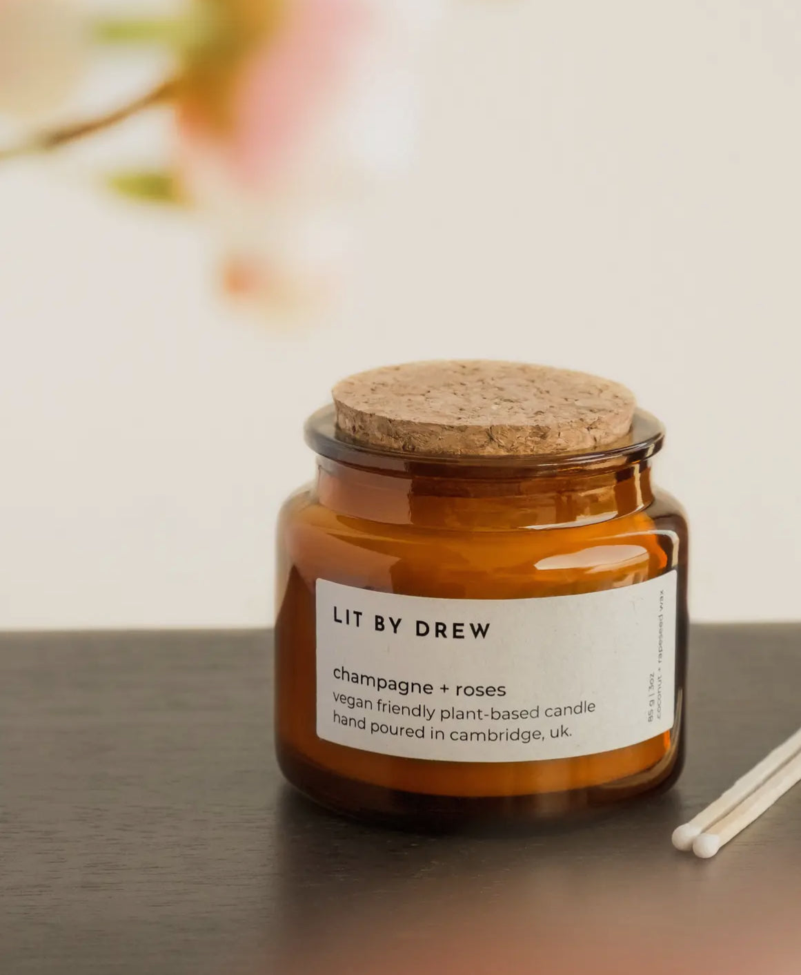 Candle jar with cork lid and label on a surface