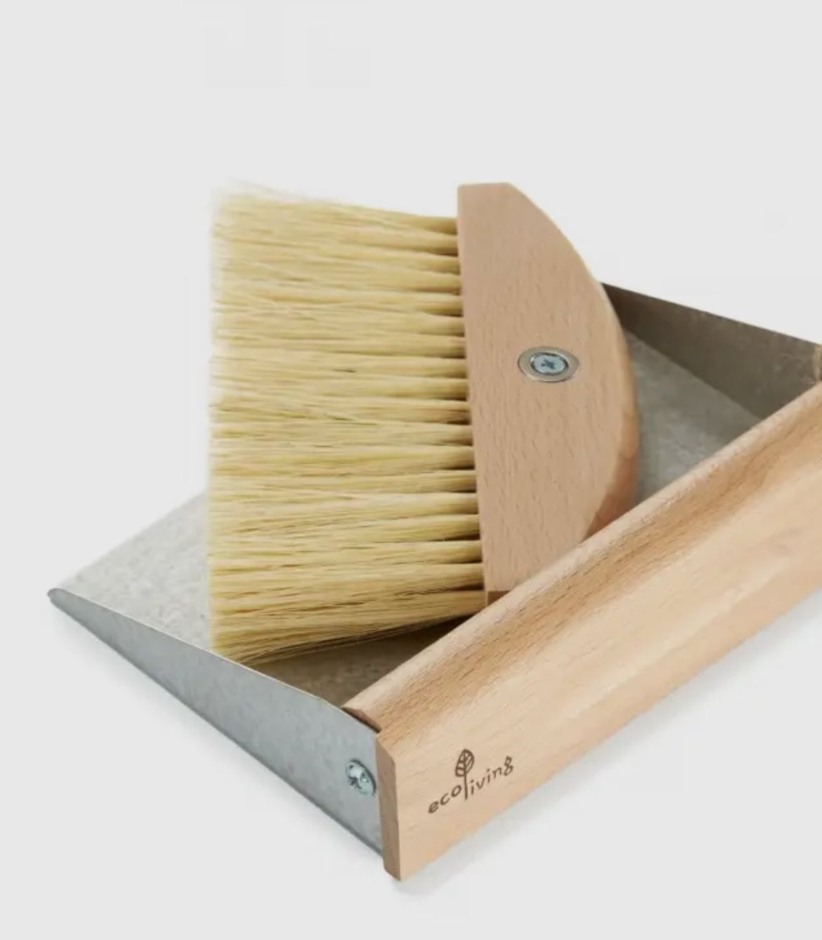 Wooden dustpan and brush set with 'eco living' branding on a light background