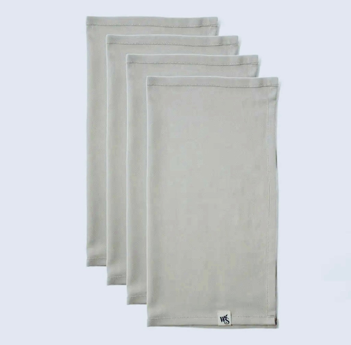 Set of three gray napkins with a brand logo on a light gray background