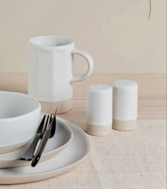White ceramic mug, bowls, and Organics Salt & Pepper Shakers on a neutral background