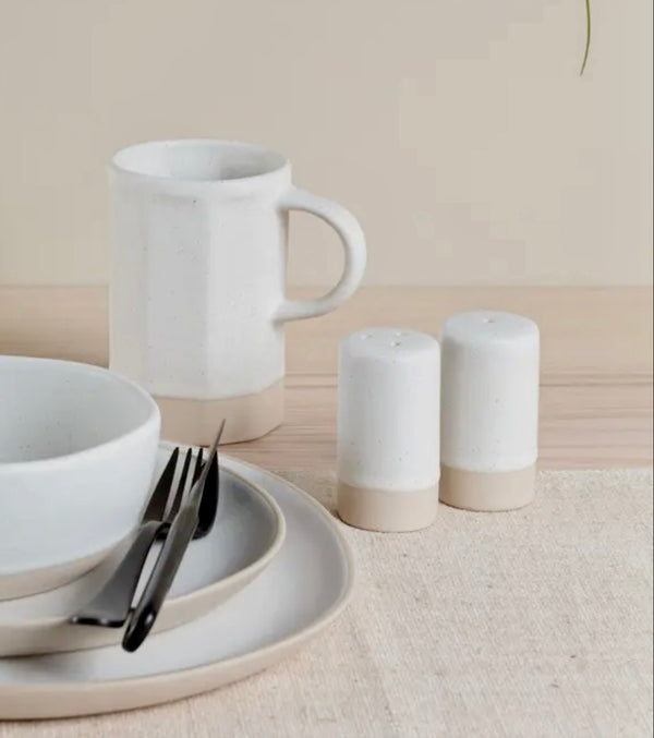 White ceramic mug, bowls, and Organics Salt & Pepper Shakers on a neutral background