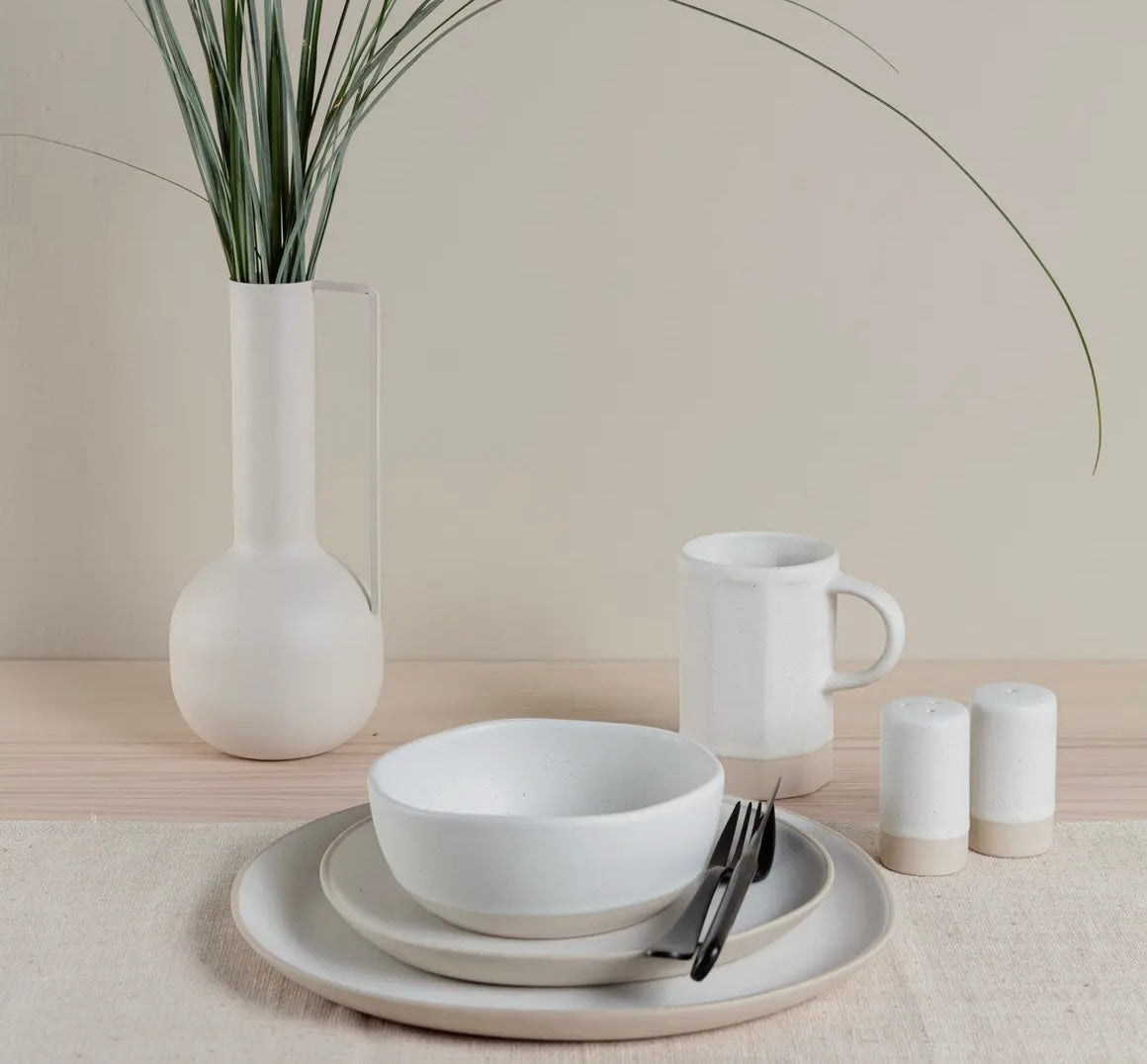 White ceramic tableware set with a Organics Side Plate and plants on a neutral background