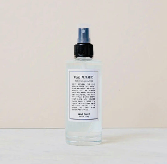 Bottle of Room and Mood Mist - Coastal Walks with a label on a beige background