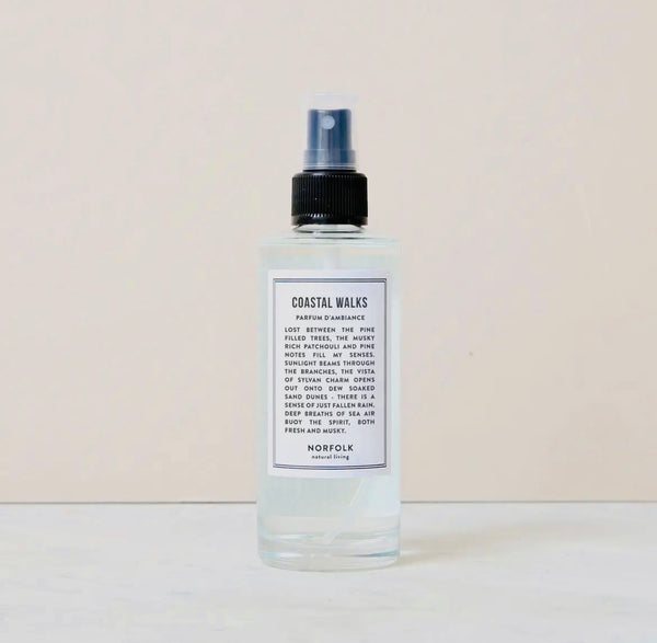 Bottle of Room and Mood Mist - Coastal Walks with a label on a beige background