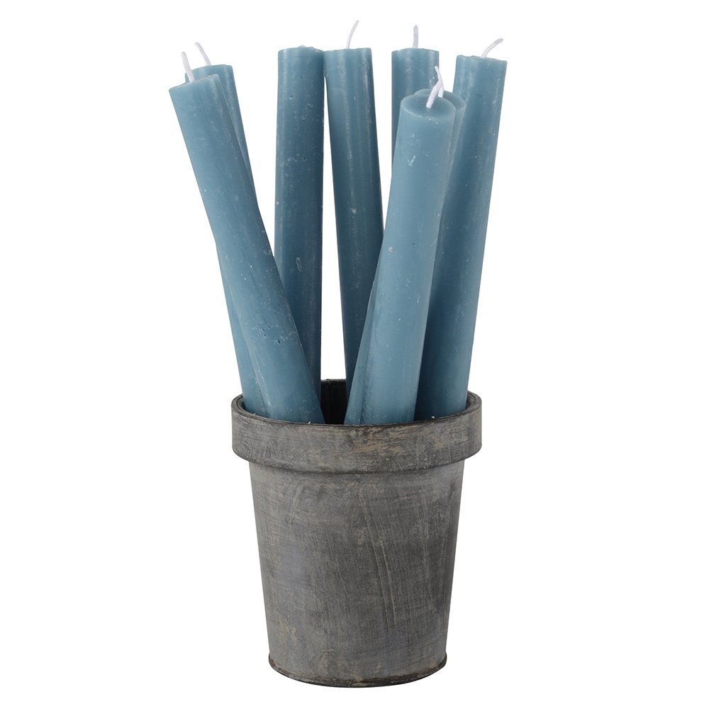 Set of blue candles in a rustic metal pot on a white background