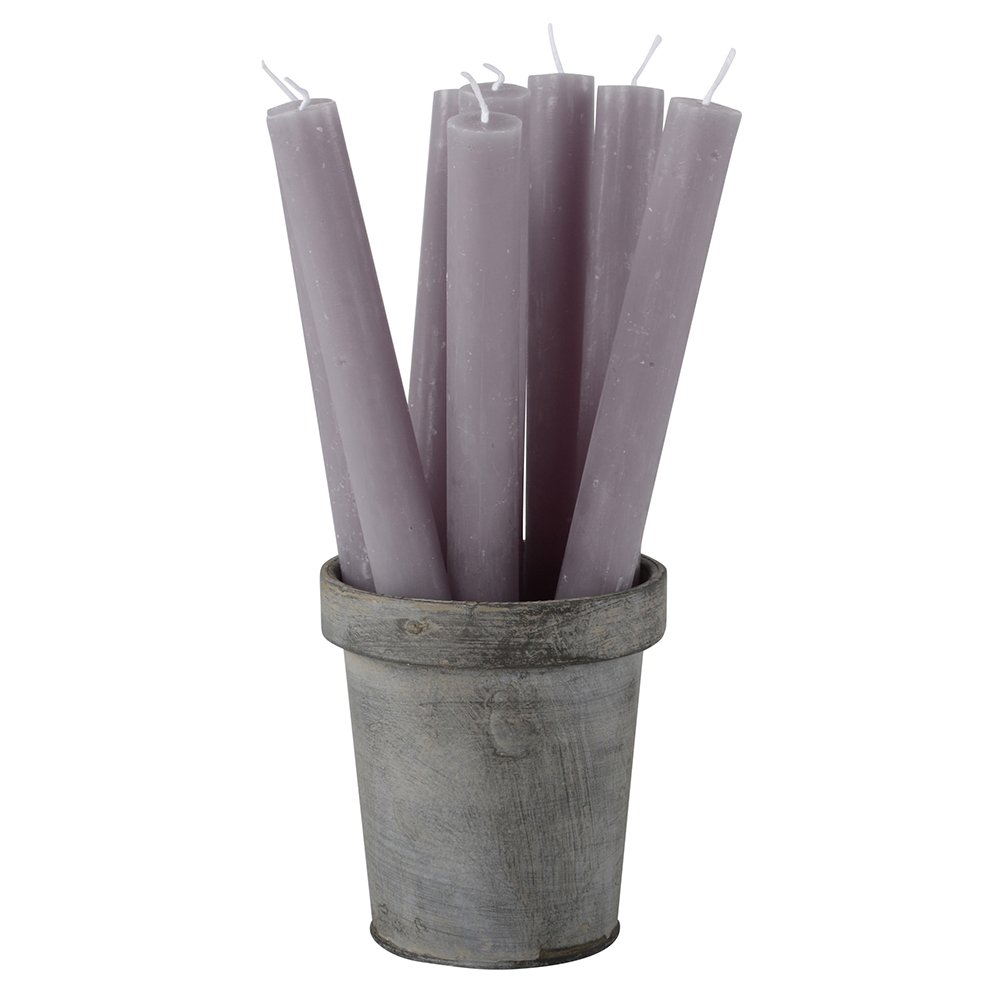 Set of purple candles in a rustic metal container on a white background