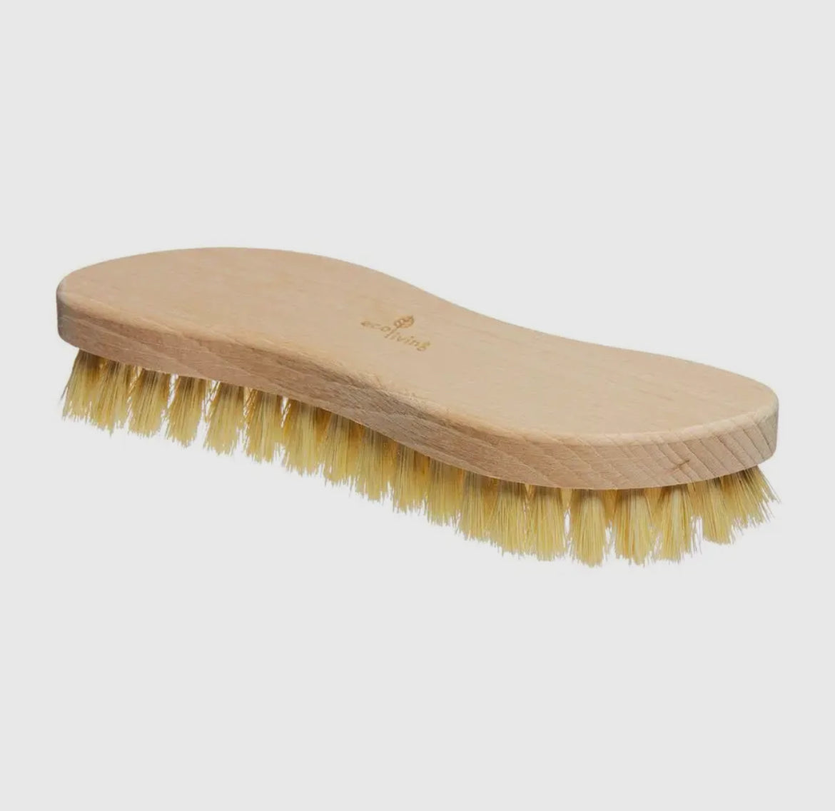 Wooden brush with natural bristles on a light gray background