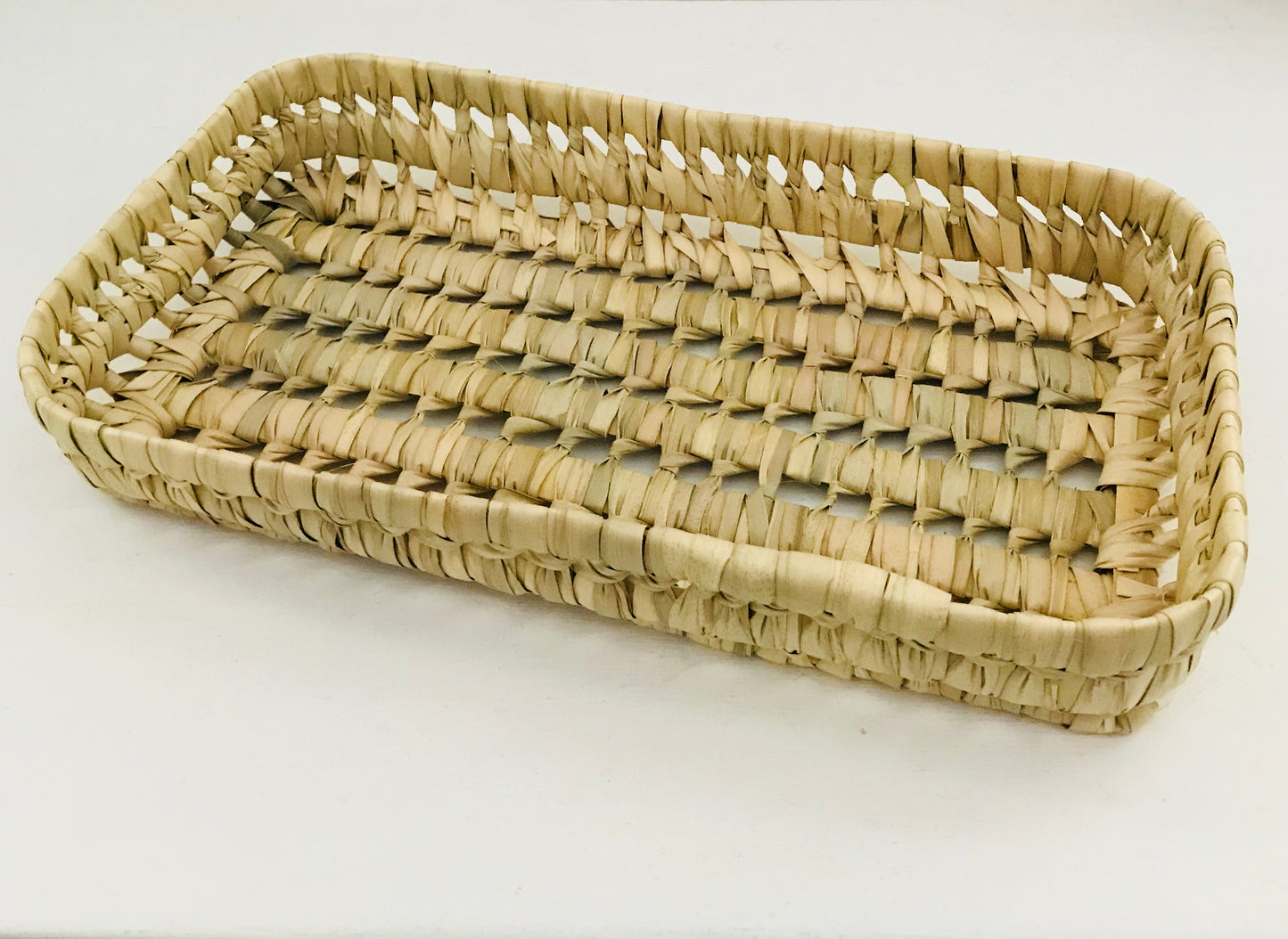 Woven rectangular basket on a white background