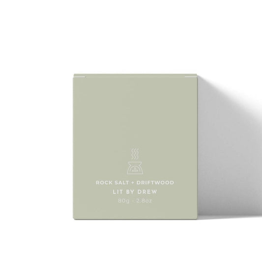 Scented product packaging with 'Lit by Drew' branding on a white background