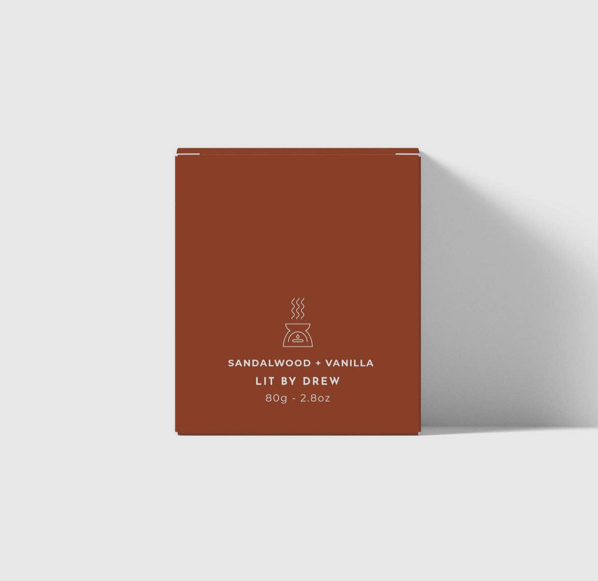Brown packaging box with 'Lit by Drew' branding on a white background