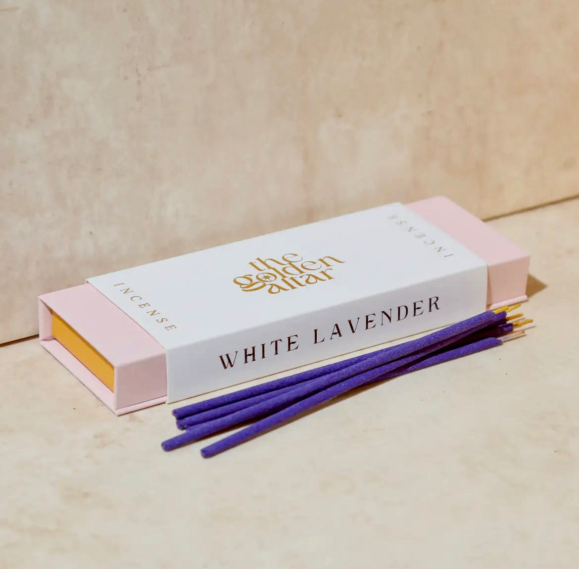 White lavender incense packaging with purple sticks on a beige background