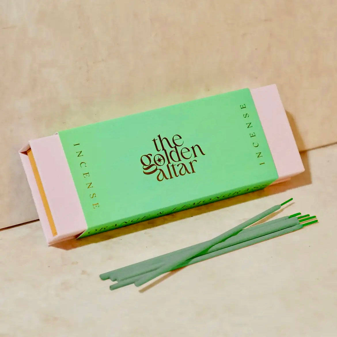 Incense packaging with 'the golden altar' branding on a beige background