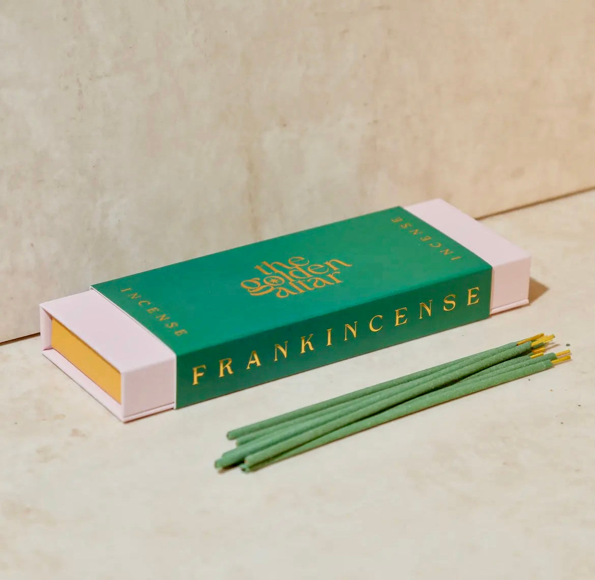 Incense sticks with a green box labeled 'Frankincense' on a beige background