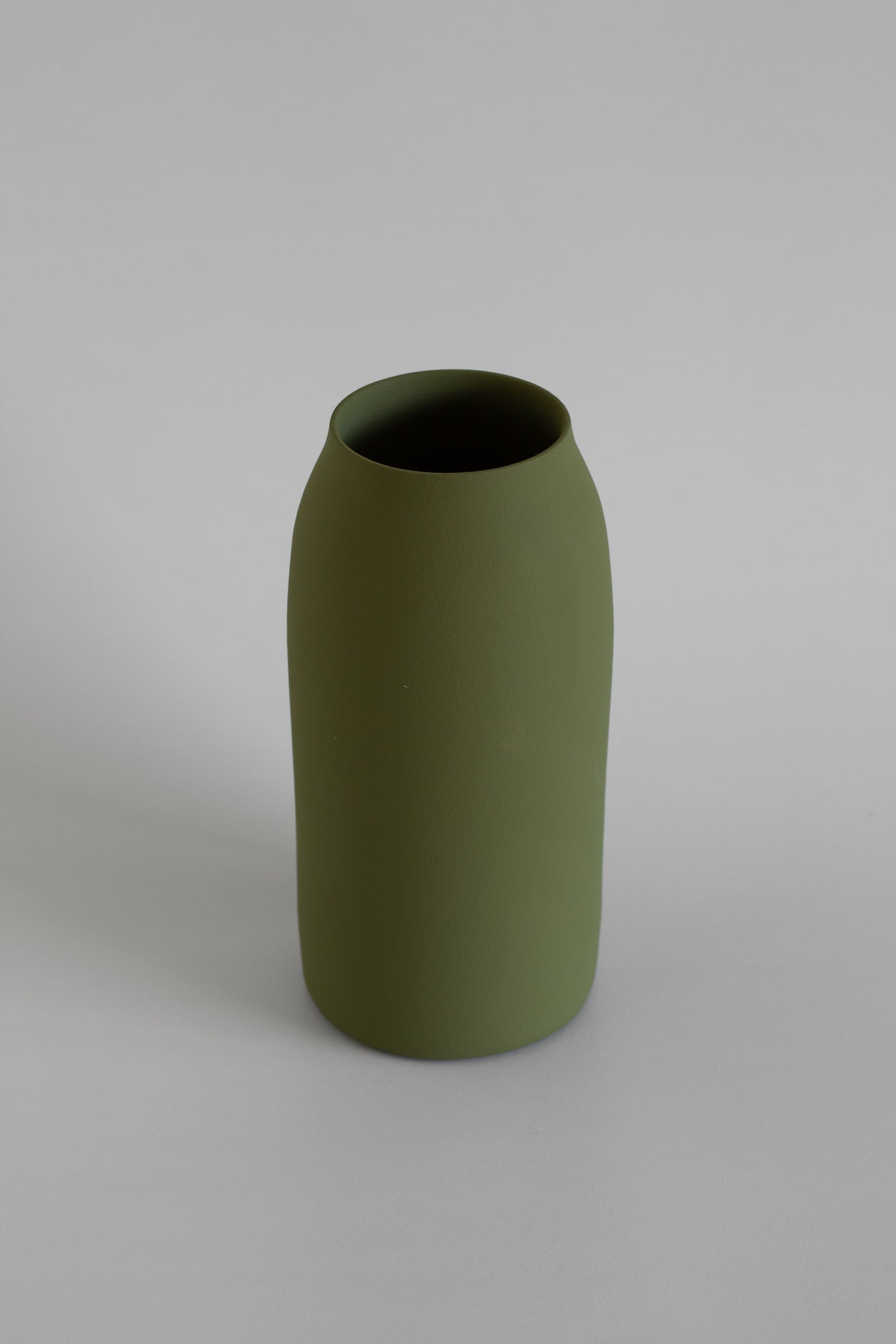 Green vase on a grey background