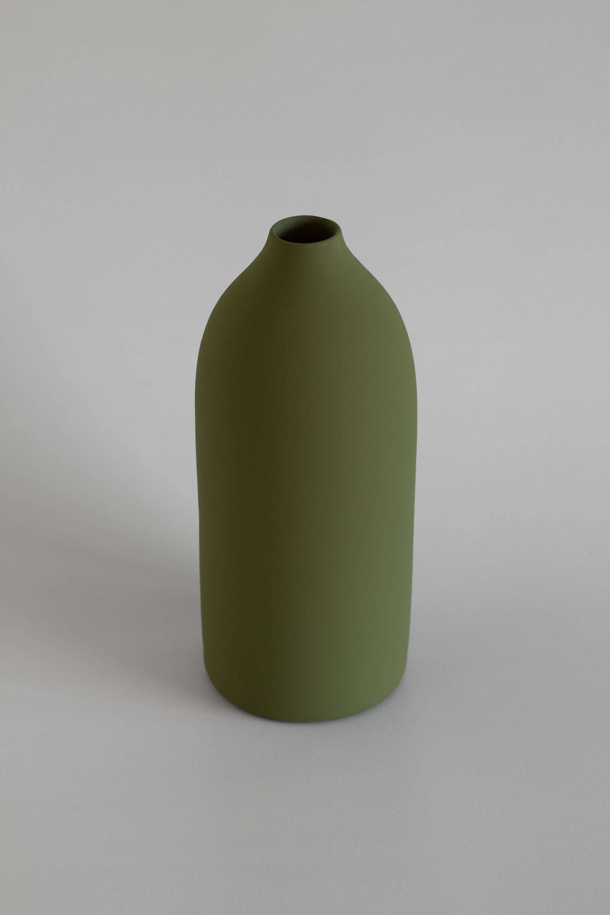 Green vase on a gray background