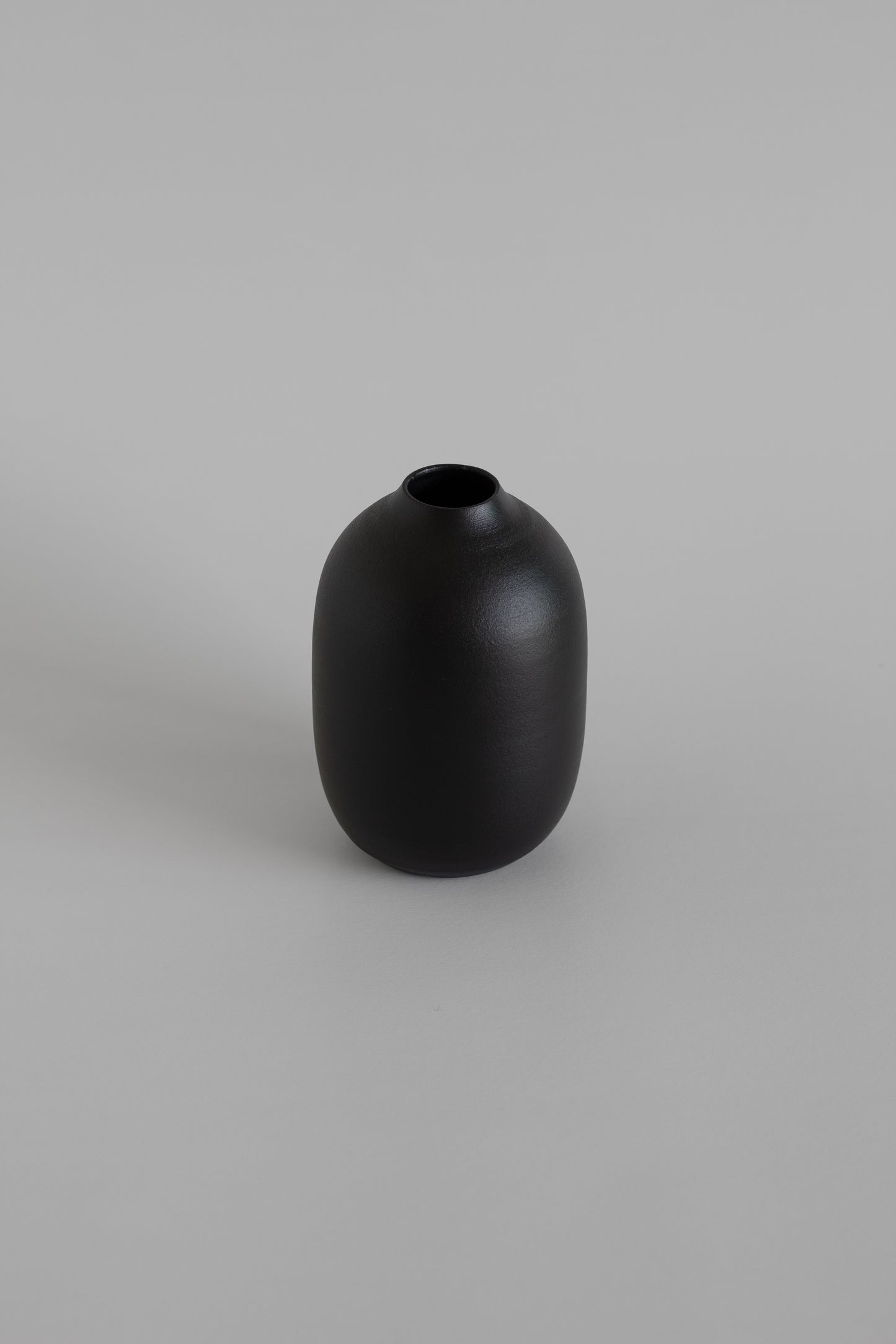 Black vase on a gray background