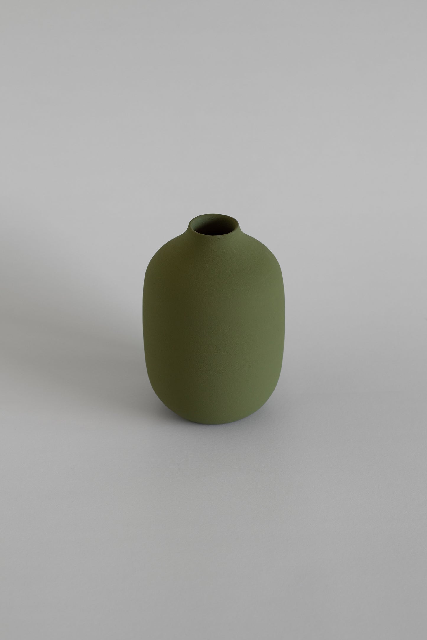 Green vase on a light gray background