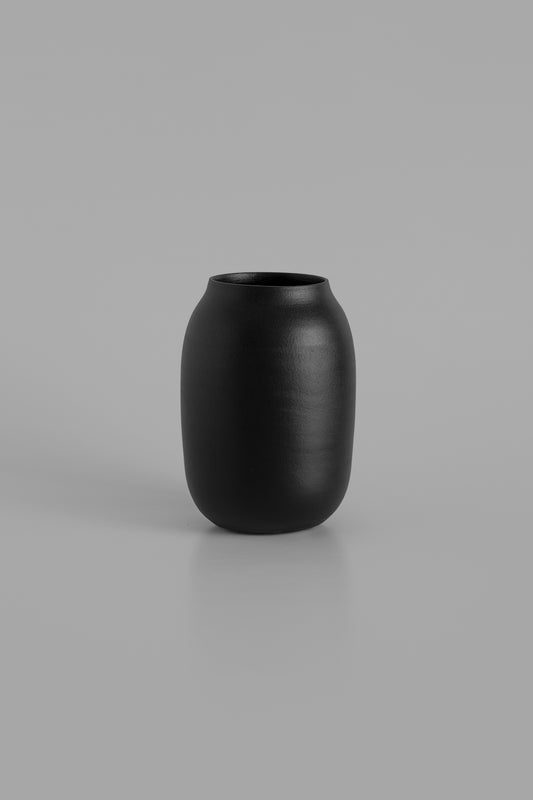 Black vase on a gray background