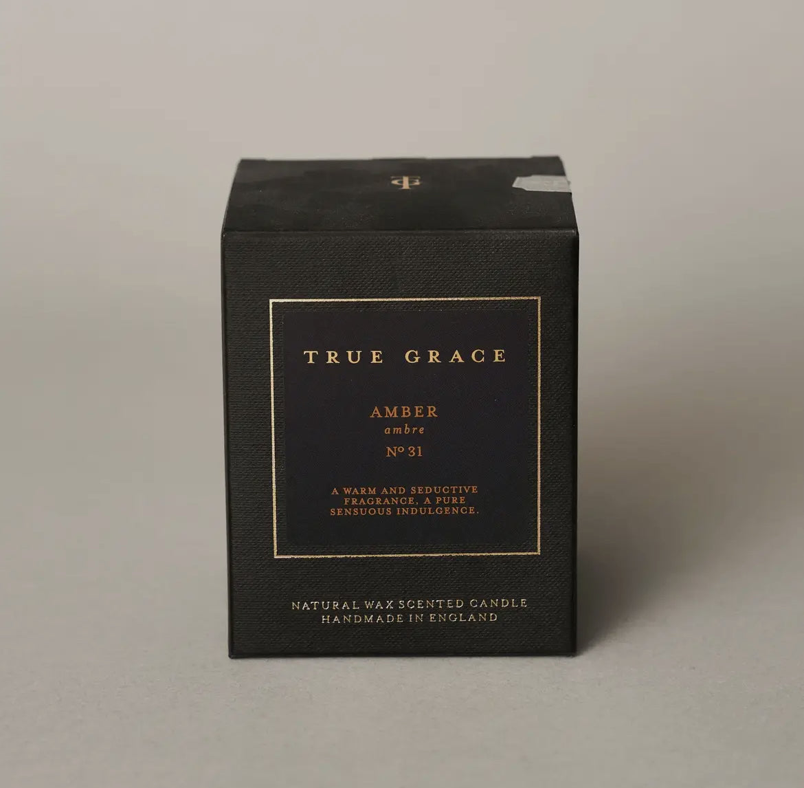 Black candle box with 'True Grace' branding on a gray background