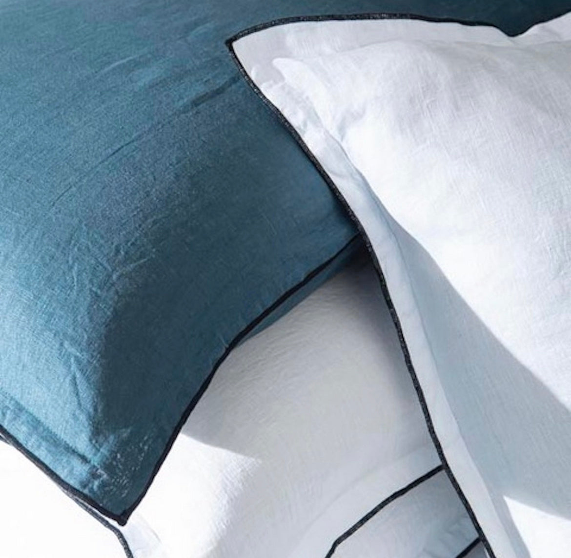 Close-up of blue and white bedding with a geometric pattern