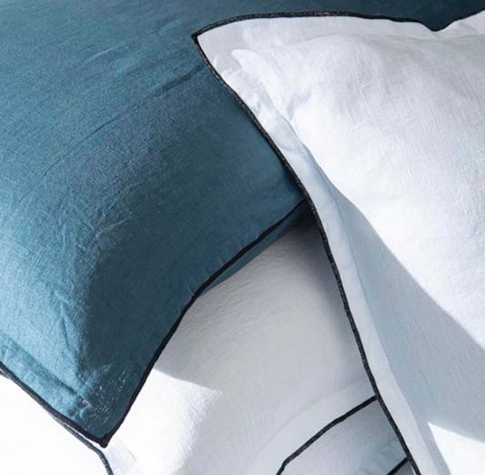 Close-up of blue and white bedding with a geometric pattern