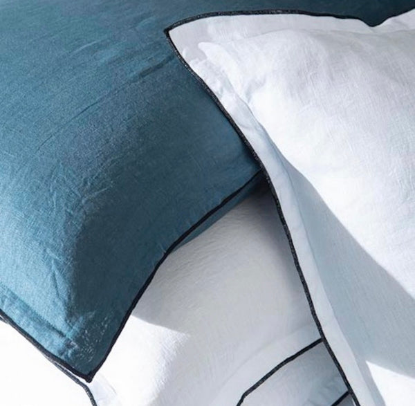 Close-up of blue and white bedding with a geometric pattern