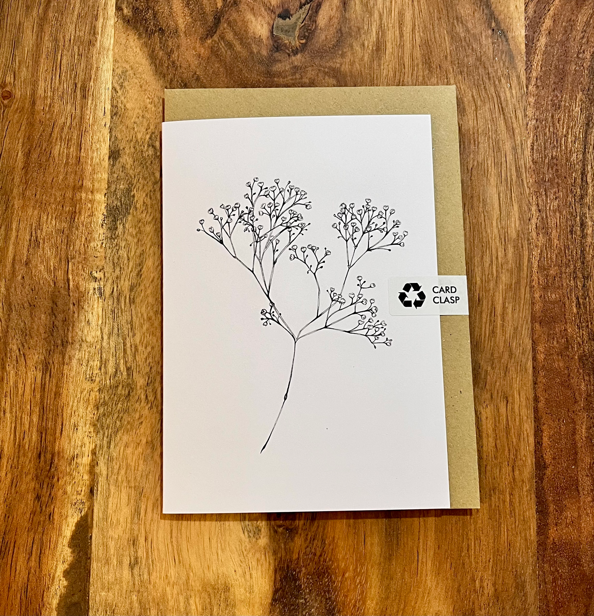 Greeting card with tree design on a wooden surface