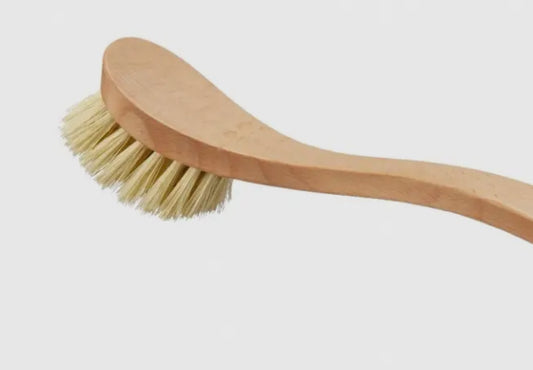 Wooden brush with bristles on a light gray background