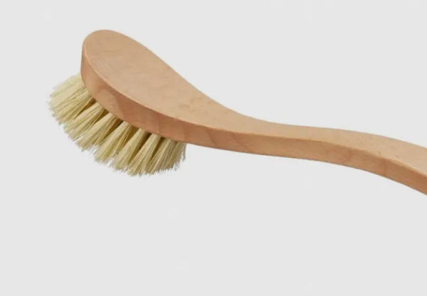 Wooden brush with bristles on a light gray background