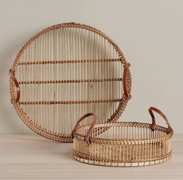 Two woven baskets with handles on a neutral background