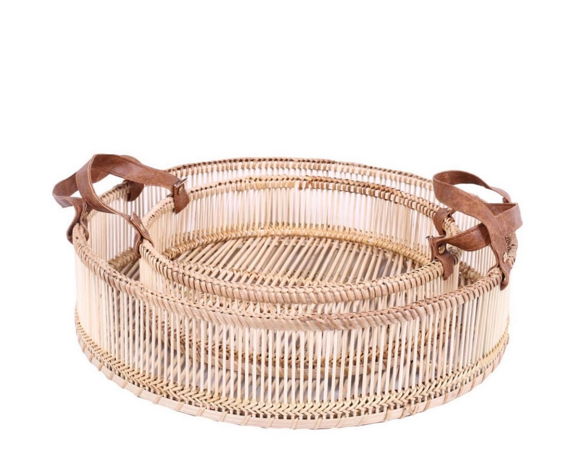 Woven basket with leather handles on a white background