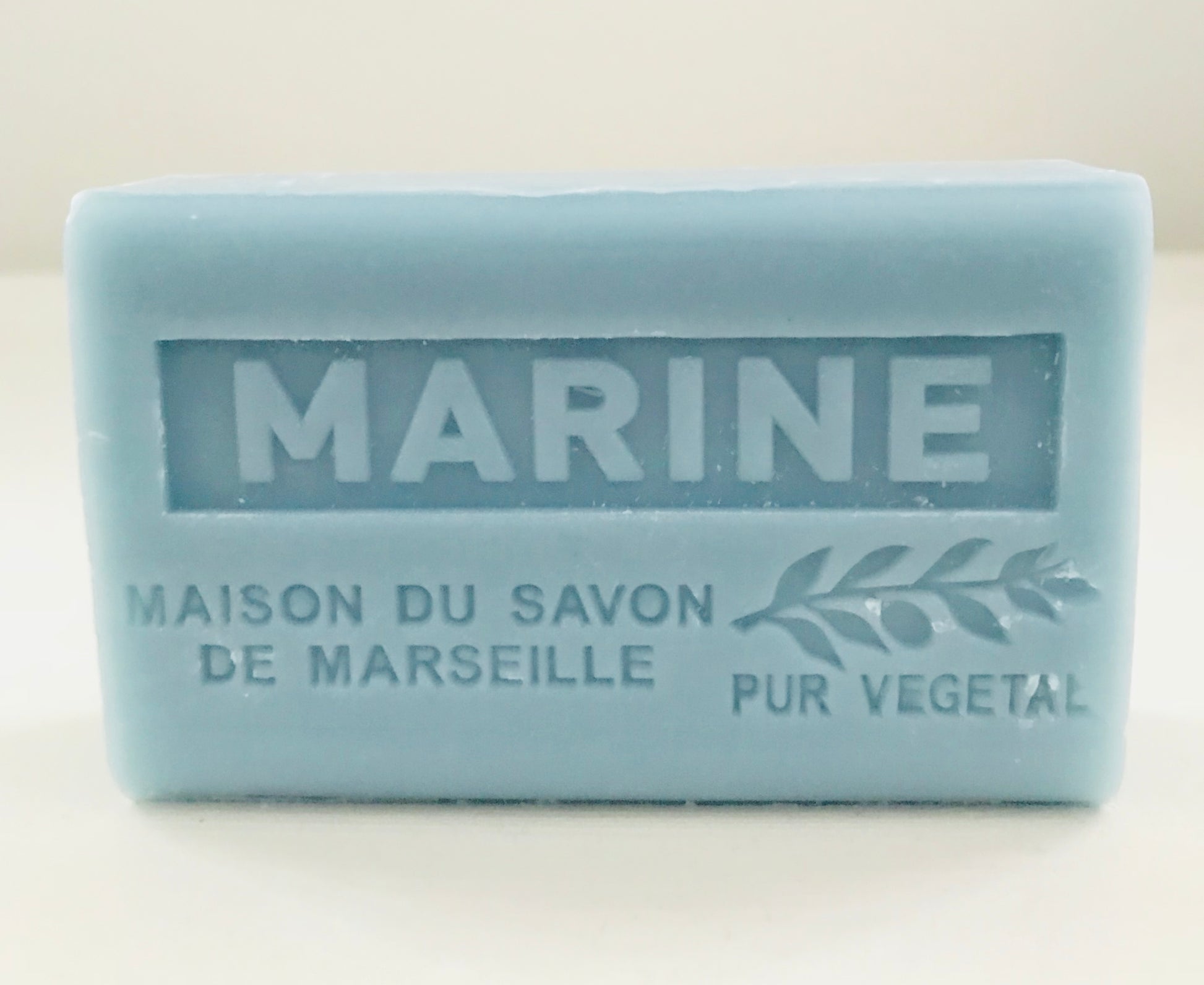 Bar of soap with 'Marine' branding on a light background